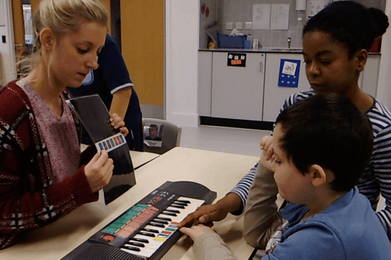 teaching autistic child to play keyboard using colour keys